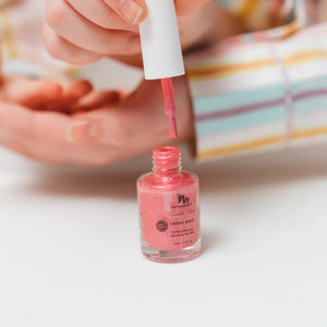 little girl painting her nails with cherry scented kids nail polish 