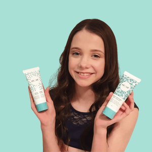 gentle-skincare-duo-cleanser-and-moisturiser-held-by-girl-with-brown-hair