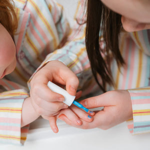 girls painting each other nails with blue nail polish