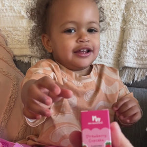 Little girl playing with strawberry lip gloss